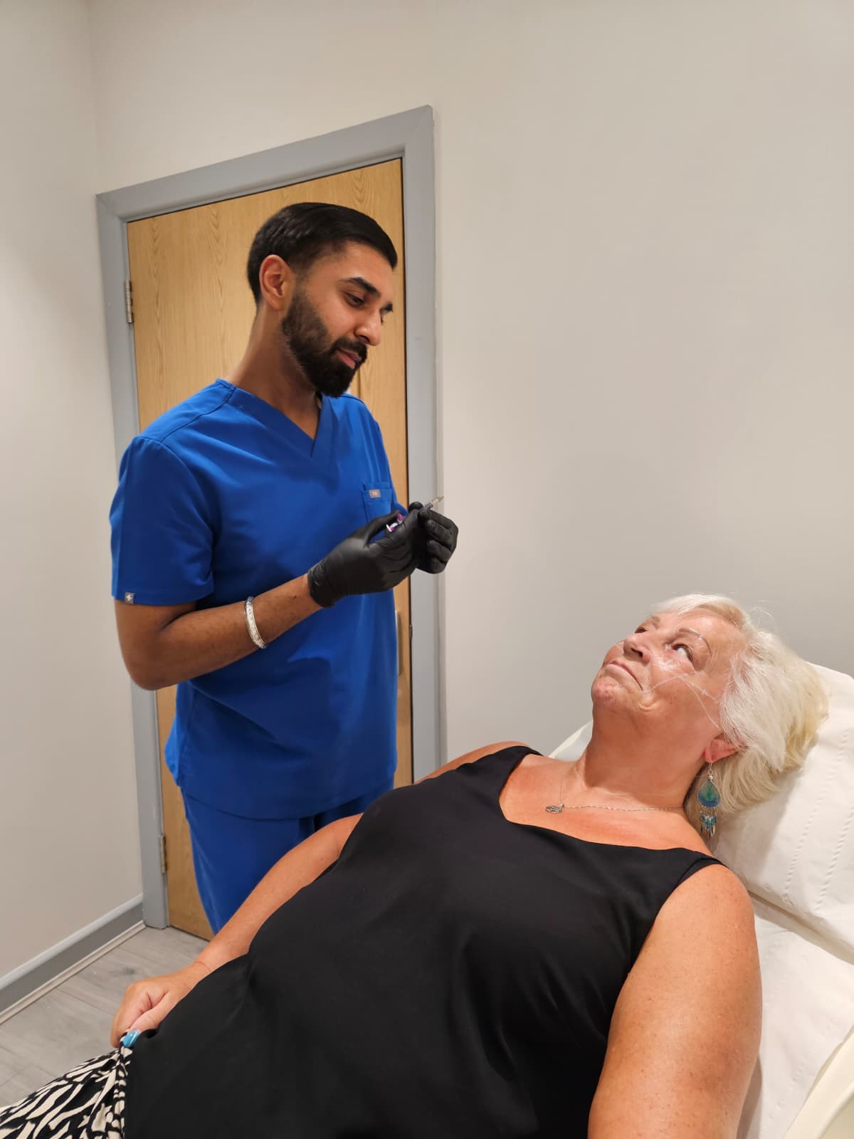 Practitioner preparing dermal filler treatment at Sidley Pharmacy